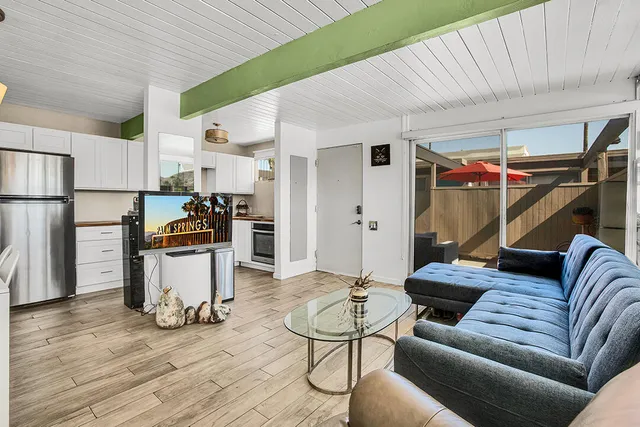 a kitchen with stainless steel appliances a stove a sink and a refrigerator