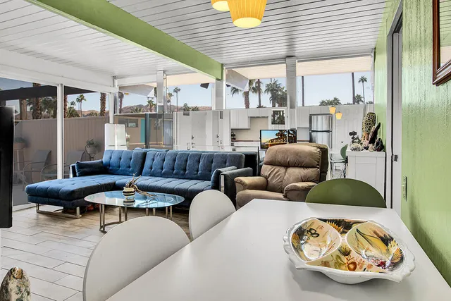 a living room with furniture a fireplace and a large window