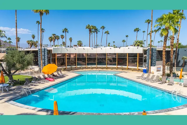 a view of a swimming pool with outdoor seating