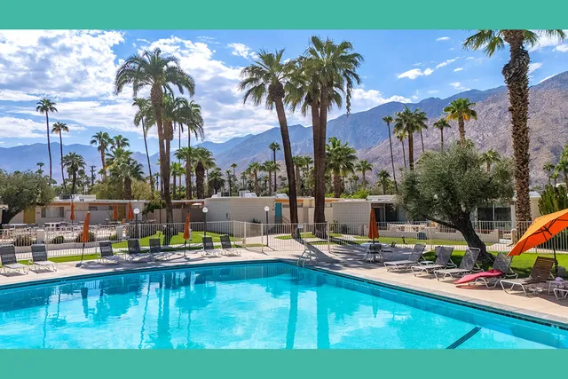 a view of a swimming pool with a table and chairs