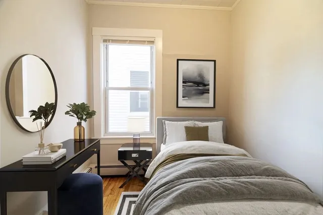 a bedroom with bed and a window