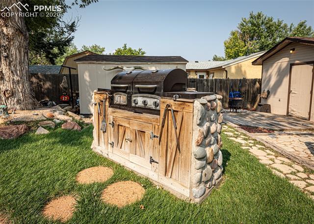 6727 Seneca Road Colorado Springs, CO 80915 - Photo 37 of 50 Custom stone/wood built-in grill, with both gas & charcoal capabilities. (Included with the home)