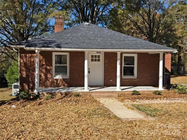 a view of house with backyard and trees around