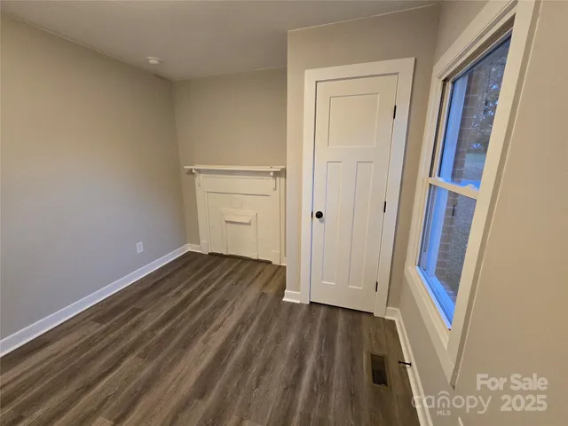 a view of a room with wooden floor and staircase