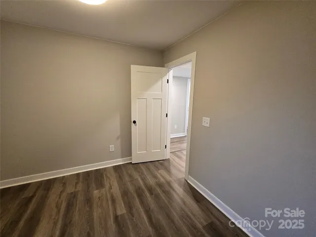 a view of an empty room and wooden floor