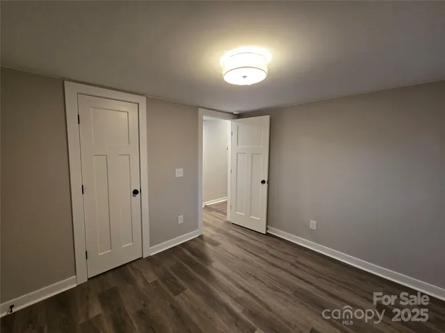 a view of an empty room and wooden floor