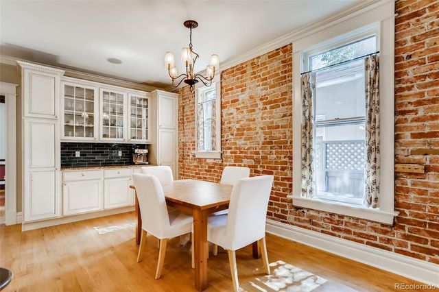 a kitchen with a refrigerator a sink and wooden floor