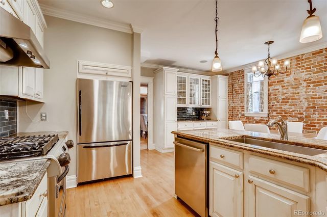 a kitchen with stainless steel appliances granite countertop a stove and a sink