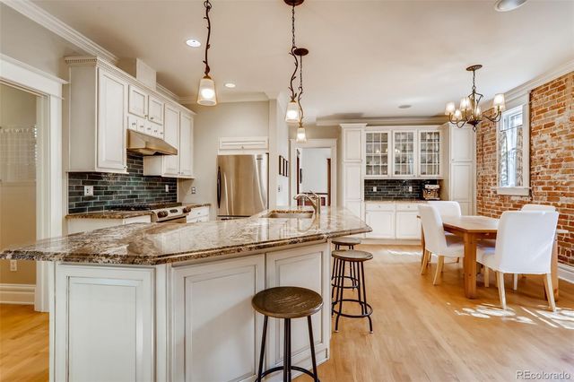 a living room with furniture a flat screen tv and a window