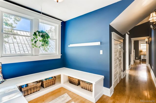 a living room with furniture and a wall painting