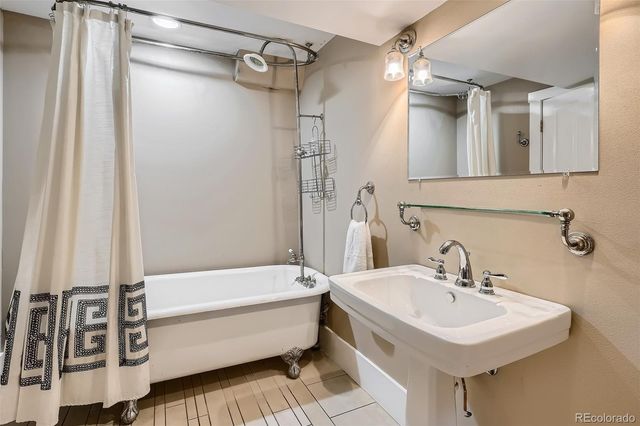 a view of a porch with furniture and wooden floor