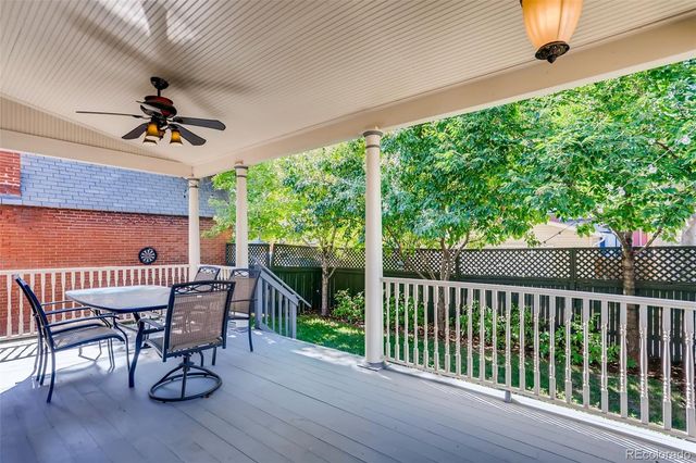 a view of a backyard with plants and a bench