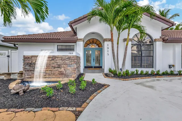 a front view of a house with garden