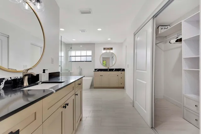 a kitchen with stainless steel appliances granite countertop a stove a refrigerator a oven a sink with a dining table and chairs