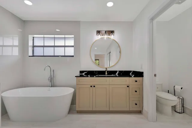 a kitchen with cabinets stainless steel appliances and wooden floor