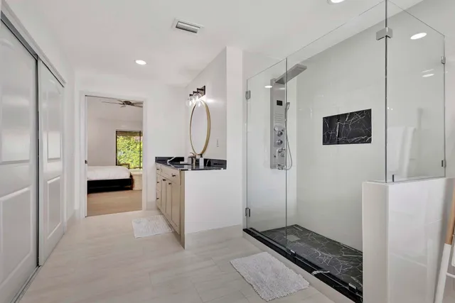 a kitchen with granite countertop stainless steel appliances white cabinets and a sink