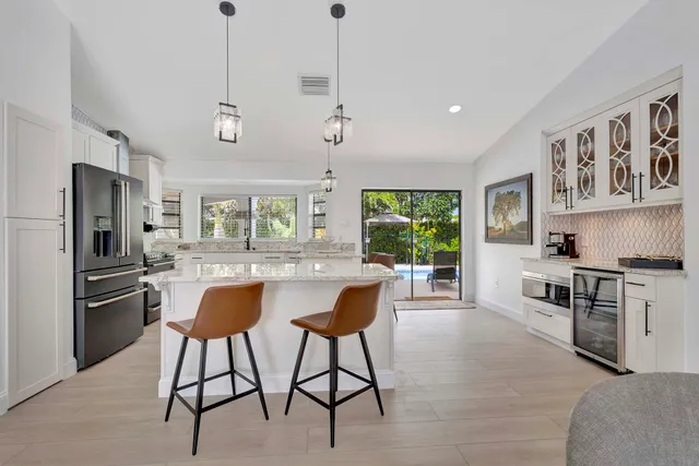 a living room with furniture and a dining room