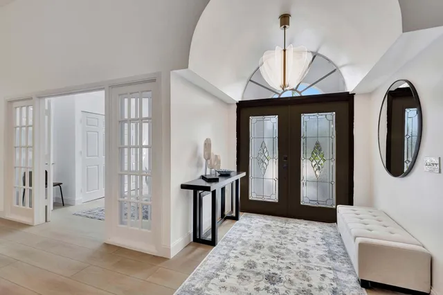 a living room with furniture a window and a potted plant
