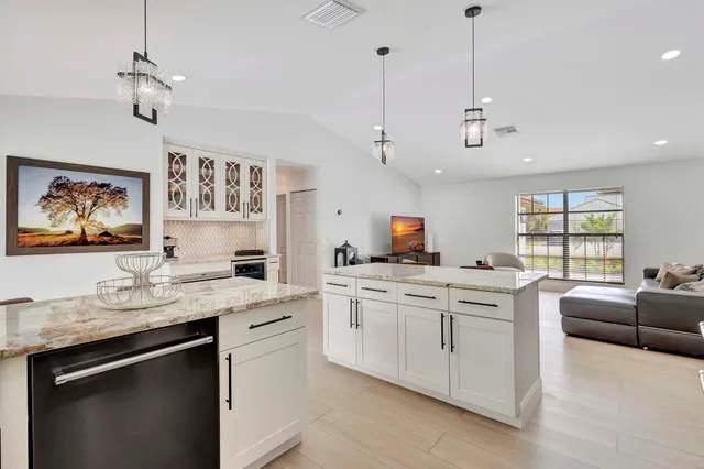 a kitchen with stainless steel appliances granite countertop a stove and cabinets