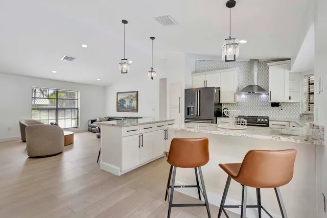 a bedroom with two beds and a chandelier