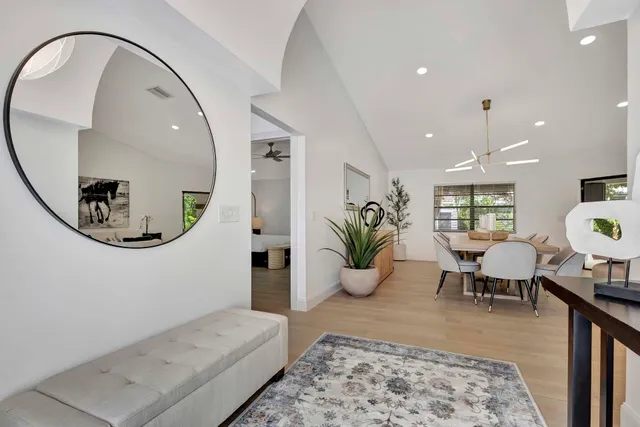 a view of a dining room with furniture and a chandelier