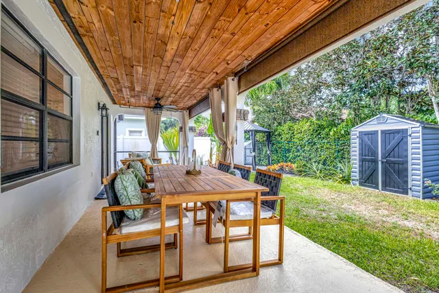 a view of a house with swimming pool and sitting area