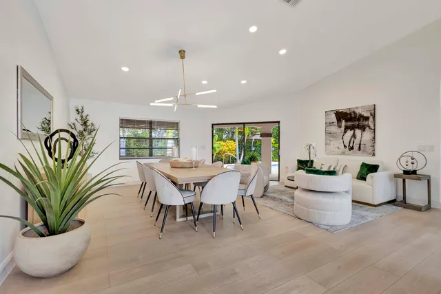 a living room with fireplace furniture and a large window