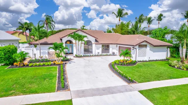 a aerial view of a house with a yard and plants