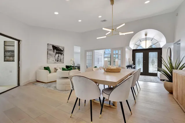 a living room with furniture a chandelier and a chandelier
