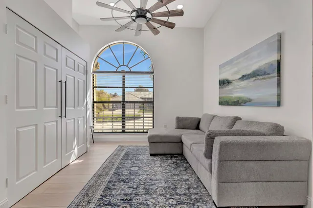 a spacious bedroom with a large bed and a flat screen tv