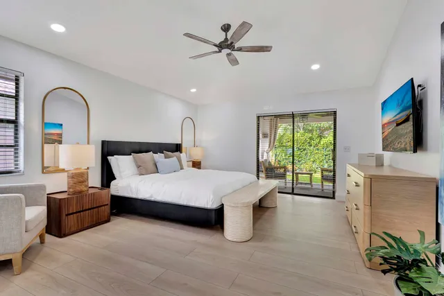 a large bathroom with a granite countertop double vanity sink a mirror and a shower