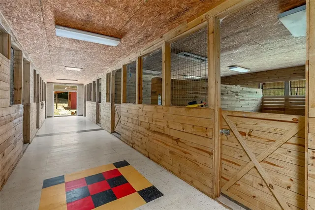 a hallway with white doors wooden floor and next to a window