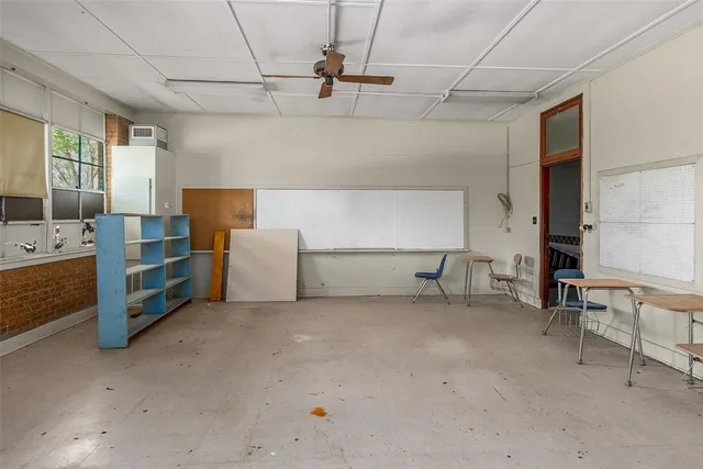 a bed room with a bed and a chair