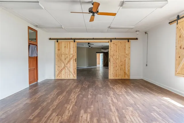 a view of a room with wooden floor