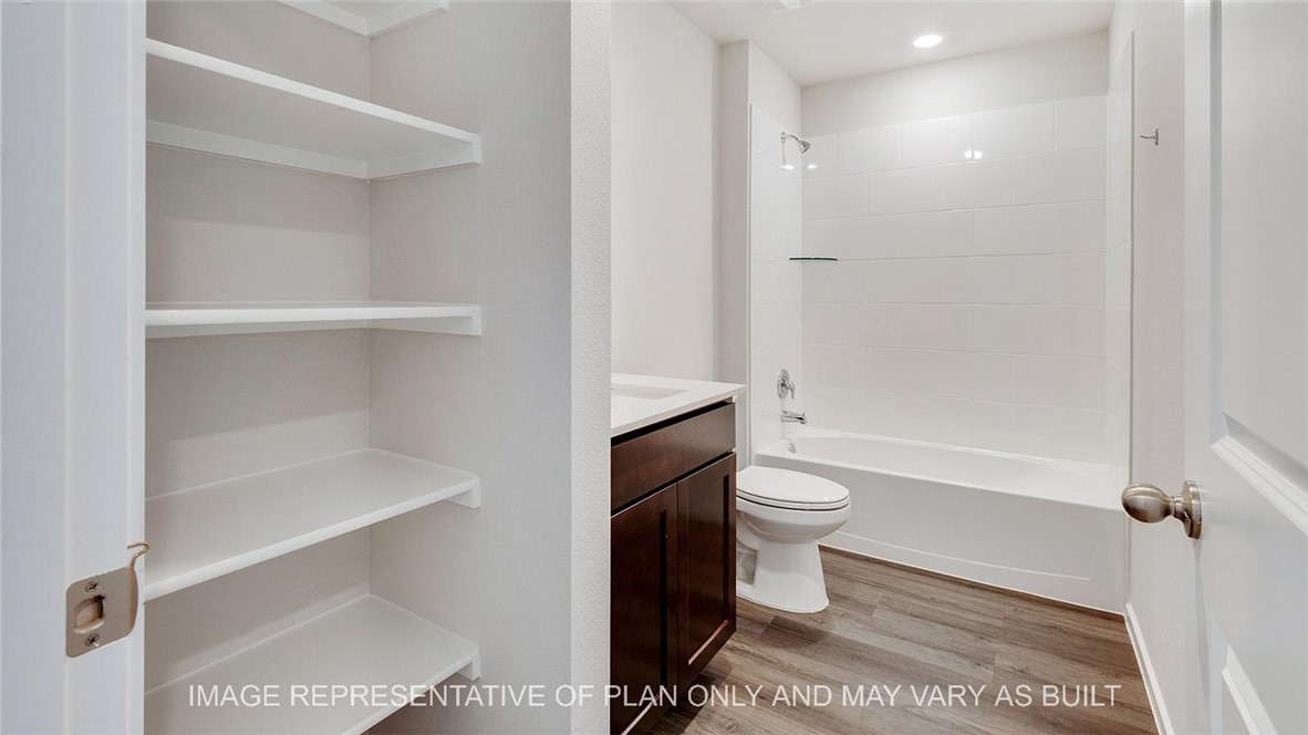 5539 Harriet Street Bryan, TX 77807 - Photo 15 of 17 a bathroom with a toilet a sink and bathtub