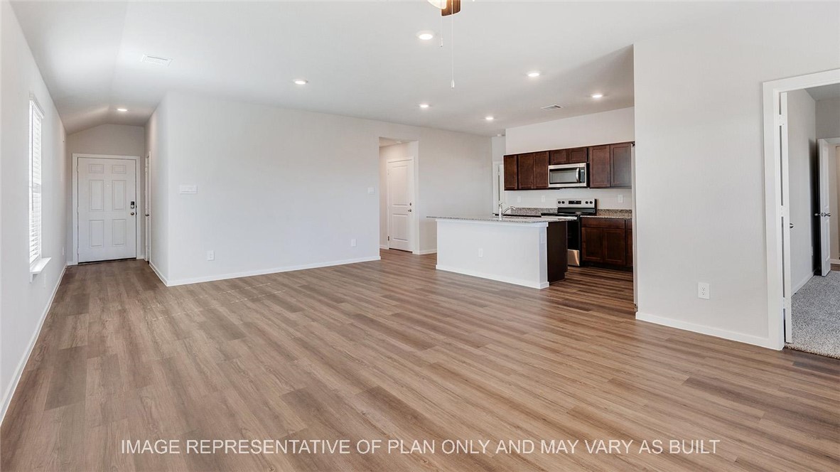 5539 Harriet Street Bryan, TX 77807 - Photo 2 of 17 a view of living room with kitchen island stainless steel appliances wooden floor and living room view