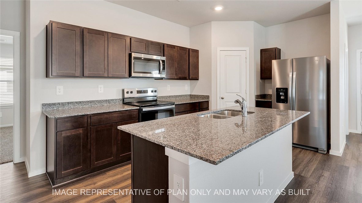 5539 Harriet Street Bryan, TX 77807 - Photo 3 of 17 a kitchen with stainless steel appliances granite countertop a sink stove and refrigerator