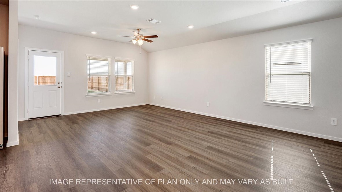 5539 Harriet Street Bryan, TX 77807 - Photo 4 of 17 an empty room with wooden floor and windows