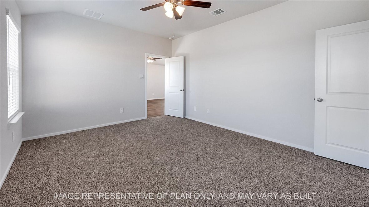 5539 Harriet Street Bryan, TX 77807 - Photo 9 of 17 an empty room with a ceiling fan and window