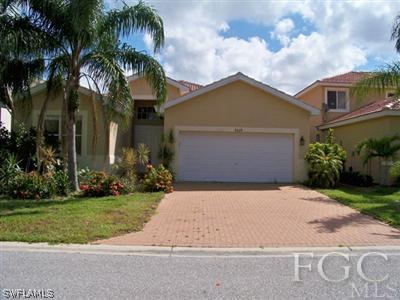 9329 Chestnut Tree Loop, Unit Q Fort Myers, FL 33967 - Photo 1 of 8 a front view of house with yard and green space