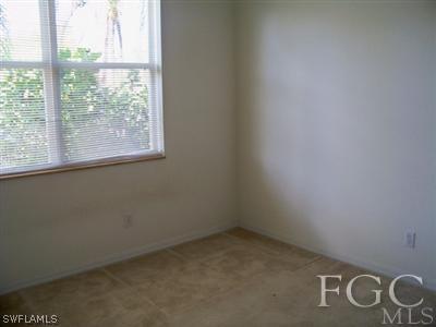 9329 Chestnut Tree Loop, Unit Q Fort Myers, FL 33967 - Photo 5 of 8 an empty room with windows