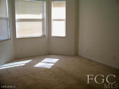 9329 Chestnut Tree Loop, Unit Q Fort Myers, FL 33967 - Photo 7 of 8 a view of an empty room with a window