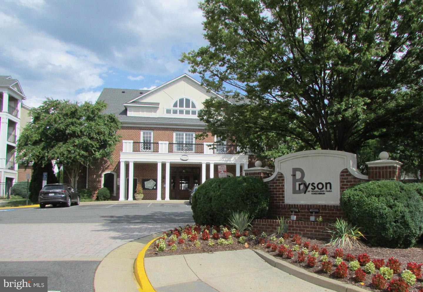 12945 Centre Park Circle, Unit 403 Herndon, VA 20171 - Photo 1 of 23 a front view of a building with garden