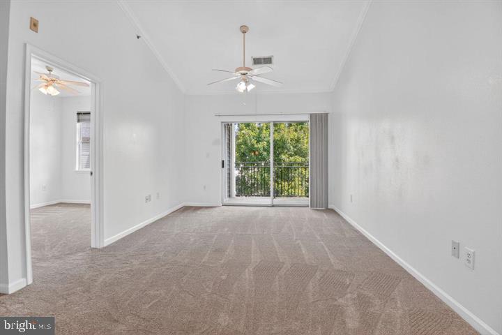 12945 Centre Park Circle, Unit 403 Herndon, VA 20171 - Photo 13 of 23 en empty room with windows and ceiling fan