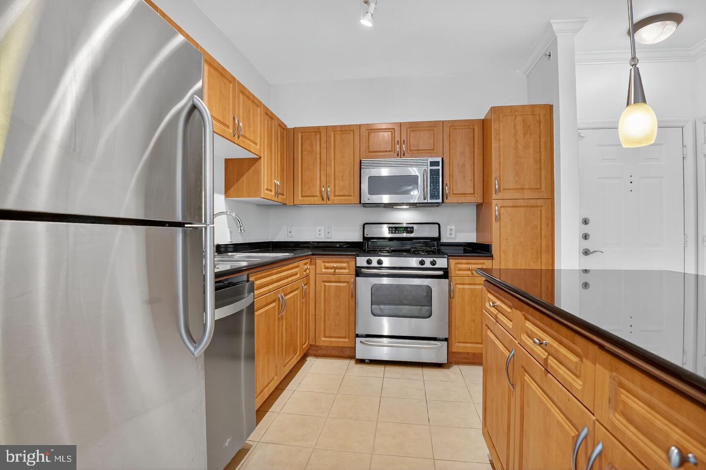 12945 Centre Park Circle, Unit 403 Herndon, VA 20171 - Photo 7 of 23 a kitchen with stainless steel appliances a refrigerator sink and microwave