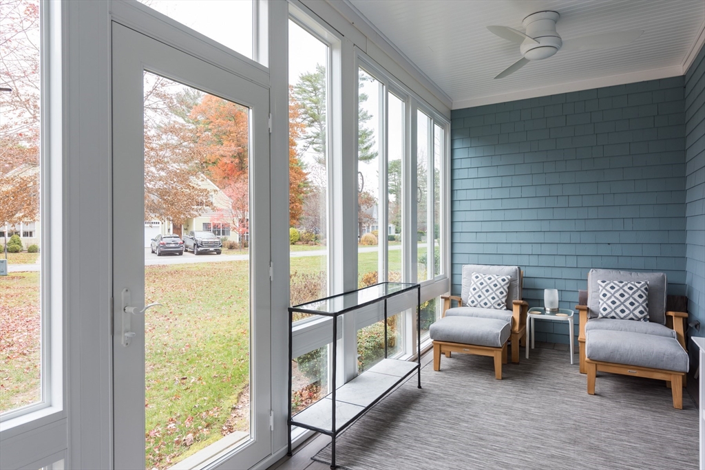 9 Hathaway Pond Circle, Unit 9 Rochester, MA 02770 - Photo 11 of 38 a balcony with furniture and rug