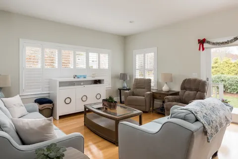 a living room with furniture and kitchen view