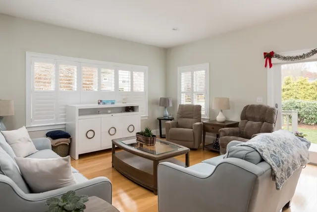 a living room with furniture and kitchen view