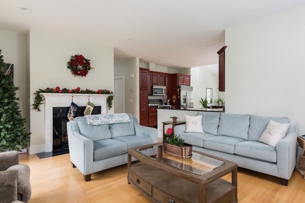 9 Hathaway Pond Circle, Unit 9 Rochester, MA 02770 - Photo 16 of 38 a living room with furniture and kitchen view
