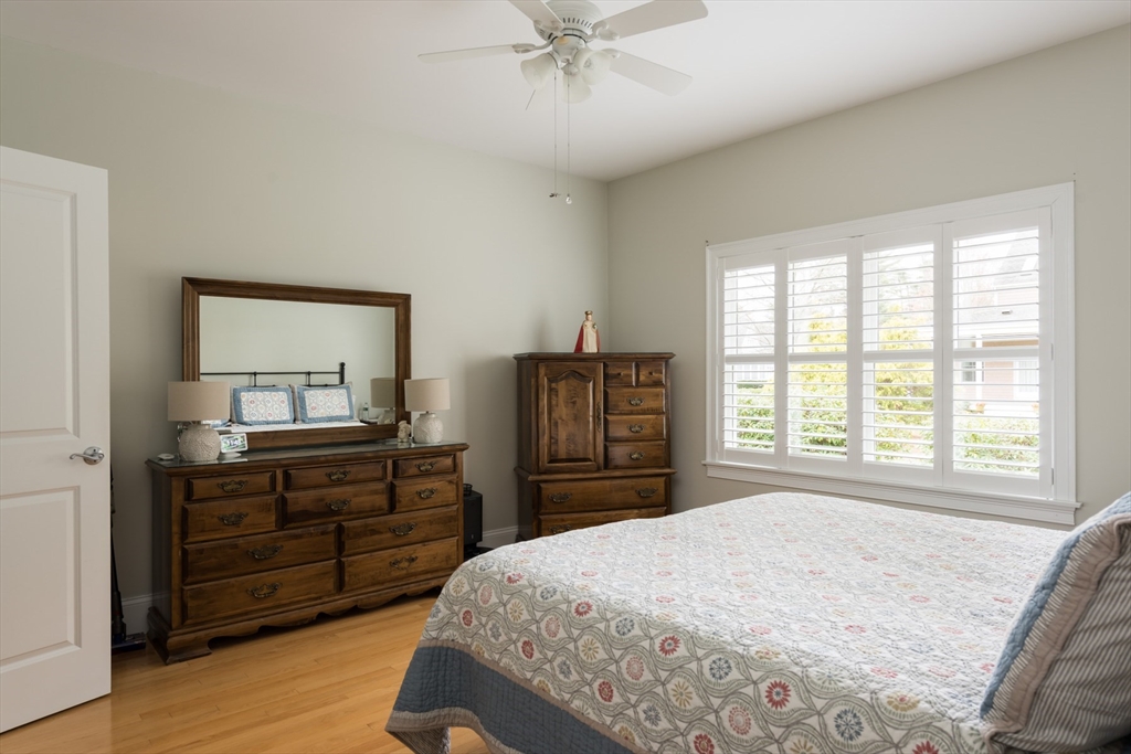9 Hathaway Pond Circle, Unit 9 Rochester, MA 02770 - Photo 18 of 38 a bedroom with a bed and a dresser